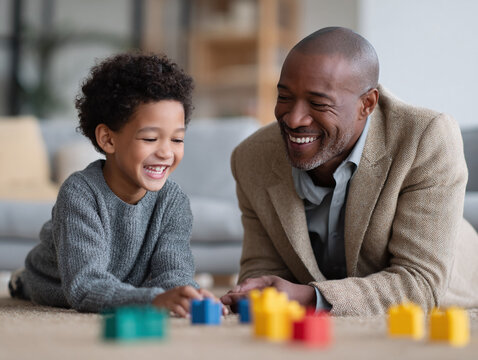 Heartwarming scene of a father and son laughing while playing with colorful blocks on the floor. Represents bonding, family time, love, and generational connection.