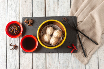 Savory Dumplings Served With Spicy Sauce and Tea