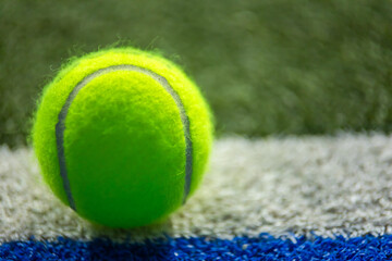 Padel or tennis ball. Background with copy space. Ball at sports court. Social media template....