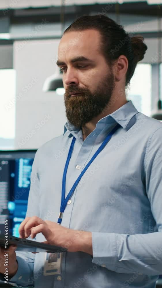 Fototapete vertical video system administrator in office developing software applications, integrating ai drive