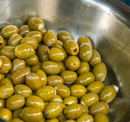 Close-Up of Garlic-Stuffed Green Olives in Stainless Bowl – Mediterranean Market Snack