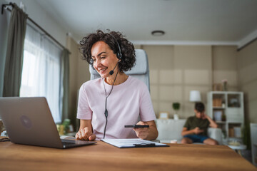 call center female agent with headset work from home use laptop