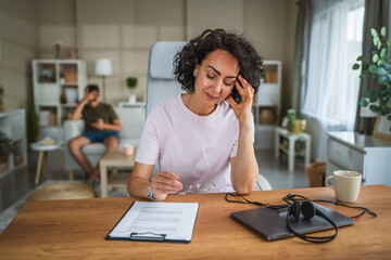 Mature woman work from home and have headache after stressful day