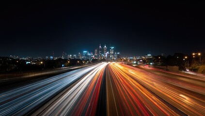 Night cityscape with a highway of blurred light trails