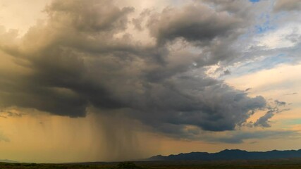 Time-lapse of a monsoon storm cloud in the Arizona desert at sunset.  - Powered by Adobe