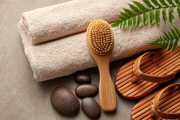 Relaxing spa arrangement featuring soft towels, natural stones, and wooden sandals for a soothing experience at a wellness retreat