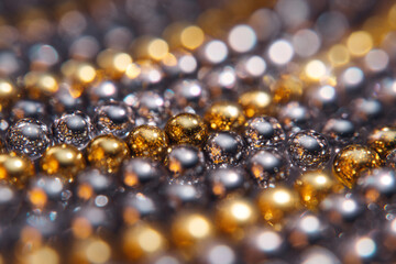 Shimmering silver and gold spheres create a mesmerizing patterned surface with reflections and depth