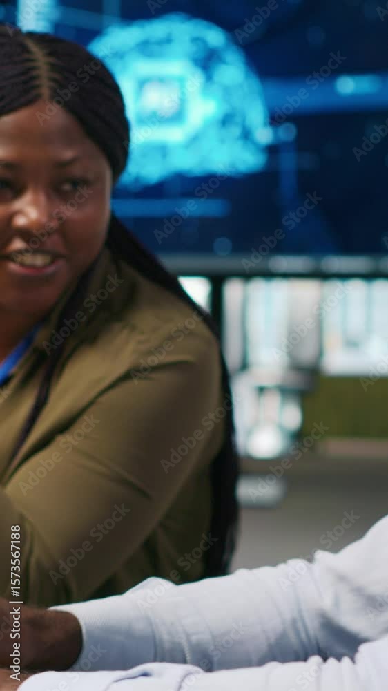 Fototapete vertical video joyous technician with disability and coworker chatting while coding ai algorithms de