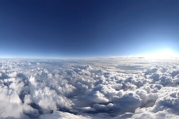 Naklejka premium Vast blue sky meets a sea of white clouds, sun bright on the horizon, panoramic view from above in the atmosphere. View from above.