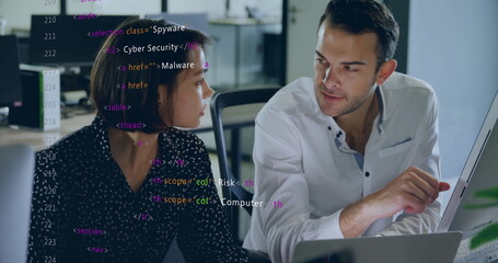 Fototapeta premium Coworkers reviewing HTML cybersecurity code in open-plan office, with computer monitor