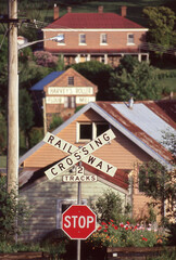 Railway crossing and stop sign and electrical power pole