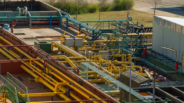 Complex network of colorful pipes, valves, and industrial infrastructure at a processing or water treatment plant