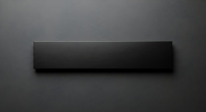 Elegant black metal nameplate on a textured dark gray wall background