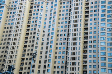 Obraz premium Modern residential apartment buildings set with sleek facades, tall high-rise structures in an urban district, contemporary real estate development.