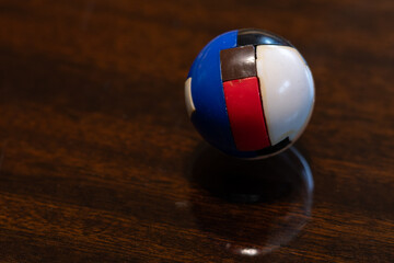 Small colorful plastic sphere used as a puzzle.
