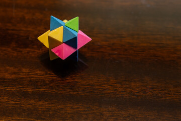 Small colorful plastic star used as a puzzle.