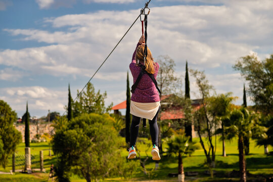 Woman riding a zip line at the park of the Prismas Basalticos in Huasca de Ocampo, Mexico