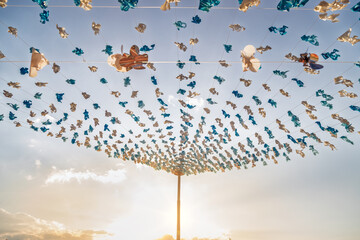 Blue and white plastic decorations with sunset backlight