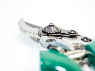 Up close view of sturdy garden pruning shears with green handle, isolated on white, ready for...