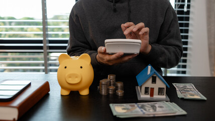 a man is calculating the money from his savings account to buy a house, this man is calculating his...