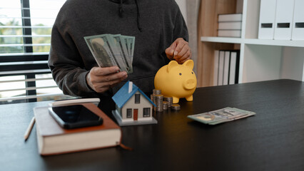 a man uses his savings to buy his dream home, this man plans his finances to buy a home, he uses...