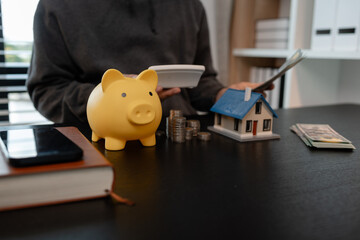 a man is calculating the money from his savings account to buy a house, this man is calculating his...