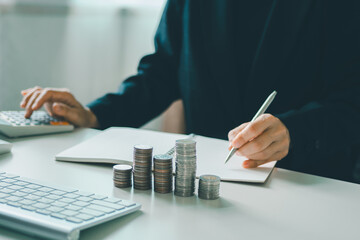 young woman using calculator calculating monthly home expenses, taxes, bank account balance and credit card bills payment, concept saving money.	