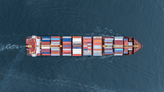Aerial view from drone, Container ship or cargo shipping business logistic import and export freight transportation by container ship in open sea, Container loading cargo freight ship boat.