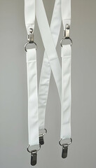 White Suspenders Hanging with Metal Clips Close Up
