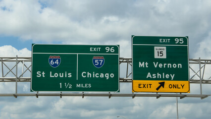 Road travel banner. Highway signs for exits on Interstate 64 in Illinois for St Louis and Chicago....
