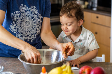 Mother and Child Cooking Together in a Kitchen with Ingredients