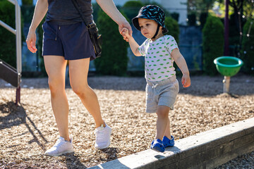 Young Boy Toddler Walking with Adult in a Vancouver Park, BC, Canada
