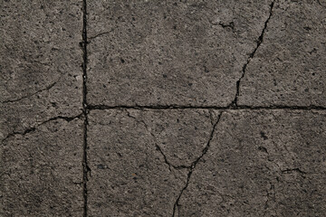 Fototapeta premium Weathered Concrete Pavement Texture, showcasing a rough, cracked surface with visible signs of aging.