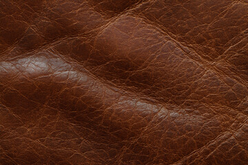 Fototapeta premium Worn Leather Texture, displaying the distinctive wrinkles and creases on a brown, aged leather surface. 