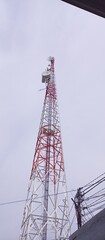 Tall Red White Telecommunication Tower with Wires
