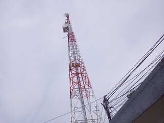 Tall Red White Telecommunication Tower with Wires