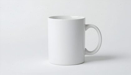 Obraz premium Minimalist white ceramic mug stands on a crisp white background, perfect for showcasing branding or a beverage.