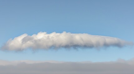 Ethereal landscape featuring a long, striated cloud formation against a soft blue sky expanse
