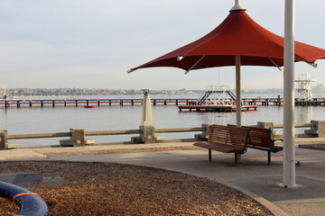 beach landscape with pier and umbrellas at eastern beach Geelong