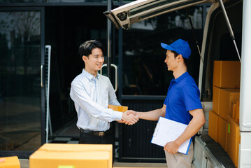 Delivery Asian man by sending box of parcel to customers service at home