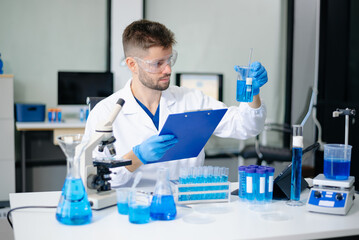 Fototapeta premium Modern medical research laboratory. male Scientists Conducting Chemistry Research in Laboratory