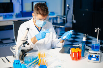scientists in lab coats conducting research, handling glassware, and working with chemicals