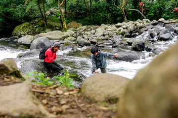 Joyful Moment During Challenging River Crossing And Having Fun While Trekking In A Jungle