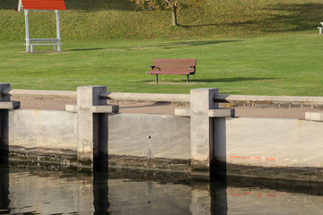 empty park bench overlooking the sea at eastern beach geelong