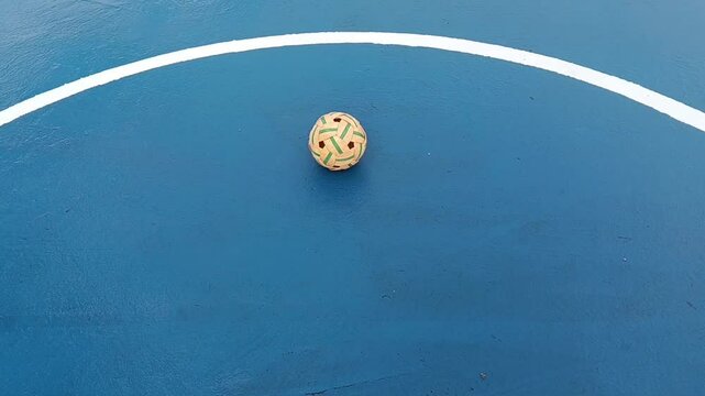 synthetic sepaktakraw or takraw or  buka ball, kick volleyball or foot volleyballball on blue background court , closeup of photo taken in malaysia.