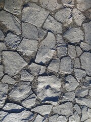 Stone pavement with irregular shapes and natural earthy gaps, rough rock texture