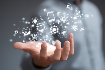 Virtual tech symbols above a persons hand, demonstrating digital interaction and control.