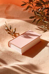 Open Book in The Sand, Underneath Shadow of Leafy Branches, Beautiful Light