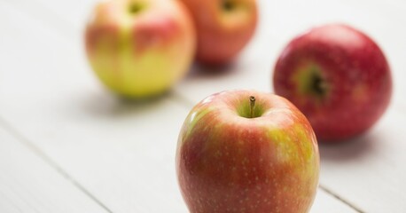 Fresh red apples on wooden table