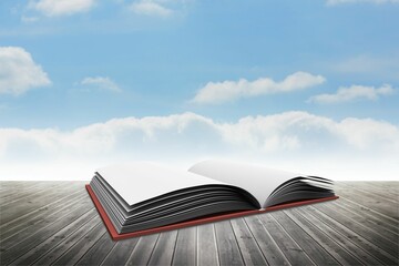 Obraz premium Flat design open red hardcover book is resting on weathered deck under blue sky with clouds